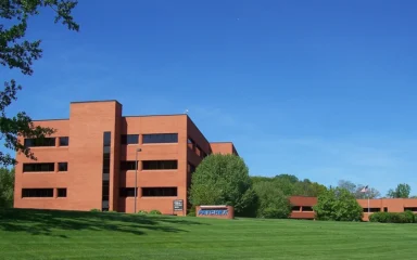 Paychex headquarters in Penfield, New York, with the Paychex sign visible in front of the building.