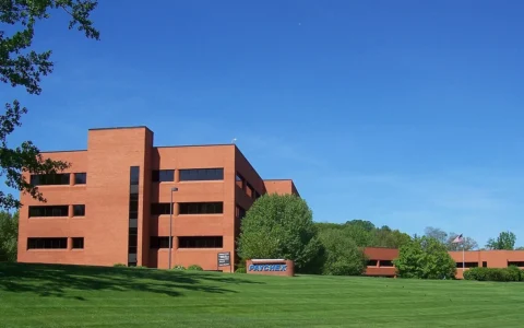 Paychex headquarters in Penfield, New York, with the Paychex sign visible in front of the building.