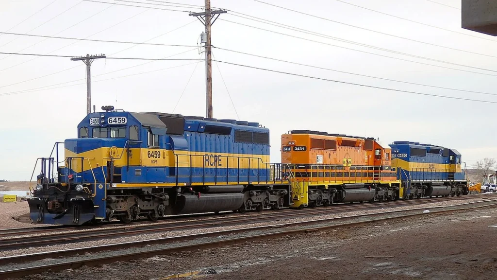 Rapid City, Pierre & Eastern Railroad locomotives 6459, 3431 and 6450 on railroad tracks.