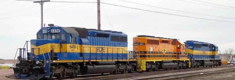Rapid City, Pierre & Eastern Railroad locomotives 6459, 3431 and 6450 on railroad tracks.