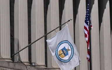 U.S. Department of Commerce flag outside the Herbert C. Hoover Building in Washington, D.C.