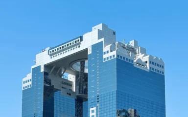 Umeda Sky Building in Osaka under a clear blue sky.