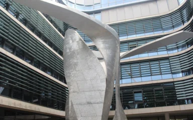 Siemens AG corporate headquarters courtyard in Munich with The Wings sculpture in the foreground.
