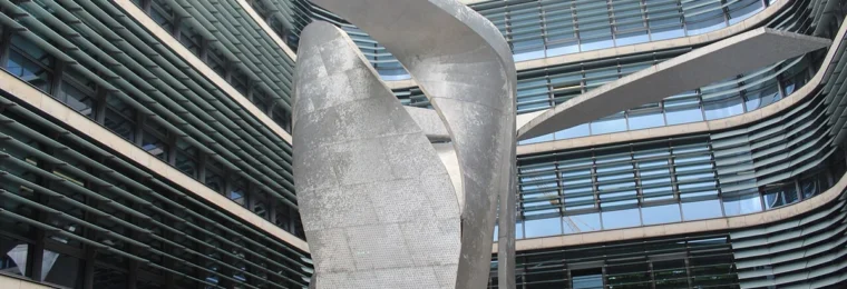 Siemens AG corporate headquarters courtyard in Munich with The Wings sculpture in the foreground.