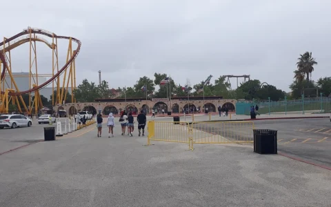 Entrance gate at Six Flags Fiesta Texas with a roller coaster visible to the left.