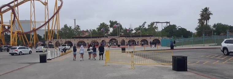 Entrance gate at Six Flags Fiesta Texas with a roller coaster visible to the left.