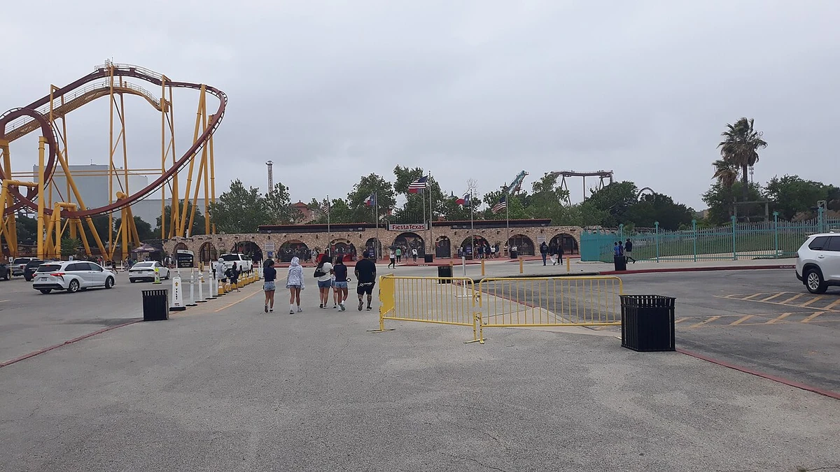 Entrance gate at Six Flags Fiesta Texas with a roller coaster visible to the left.