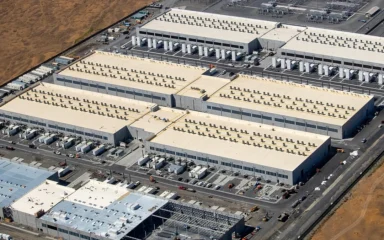 Aerial view of AWS data center buildings in Oregon, with one building under construction.