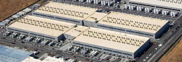 Aerial view of AWS data center buildings in Oregon, with one building under construction.
