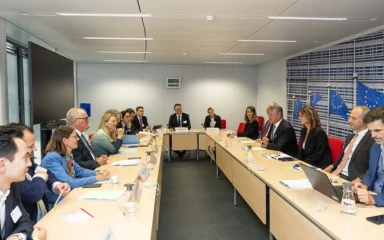 Swiss State Secretary Helene Budliger Artieda seated at a meeting table with European Commission officials in Brussels.