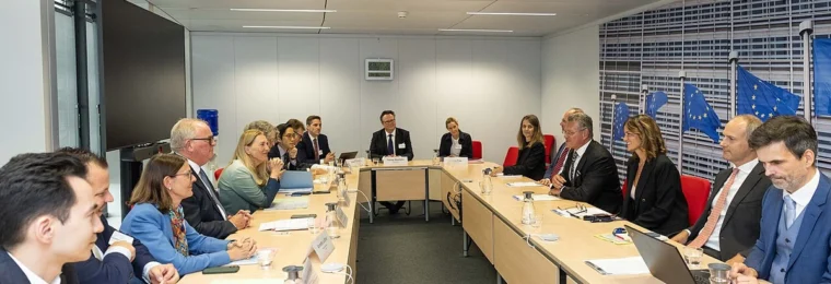 Swiss State Secretary Helene Budliger Artieda seated at a meeting table with European Commission officials in Brussels.