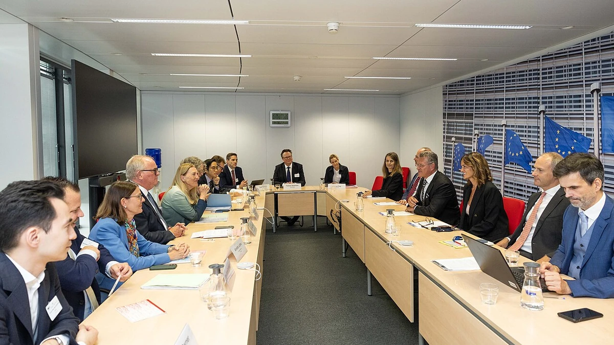 Swiss State Secretary Helene Budliger Artieda seated at a meeting table with European Commission officials in Brussels.