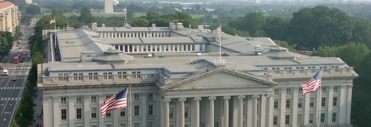 U.S. Treasury Building in Washington, D.C., with the Washington Monument in the background.