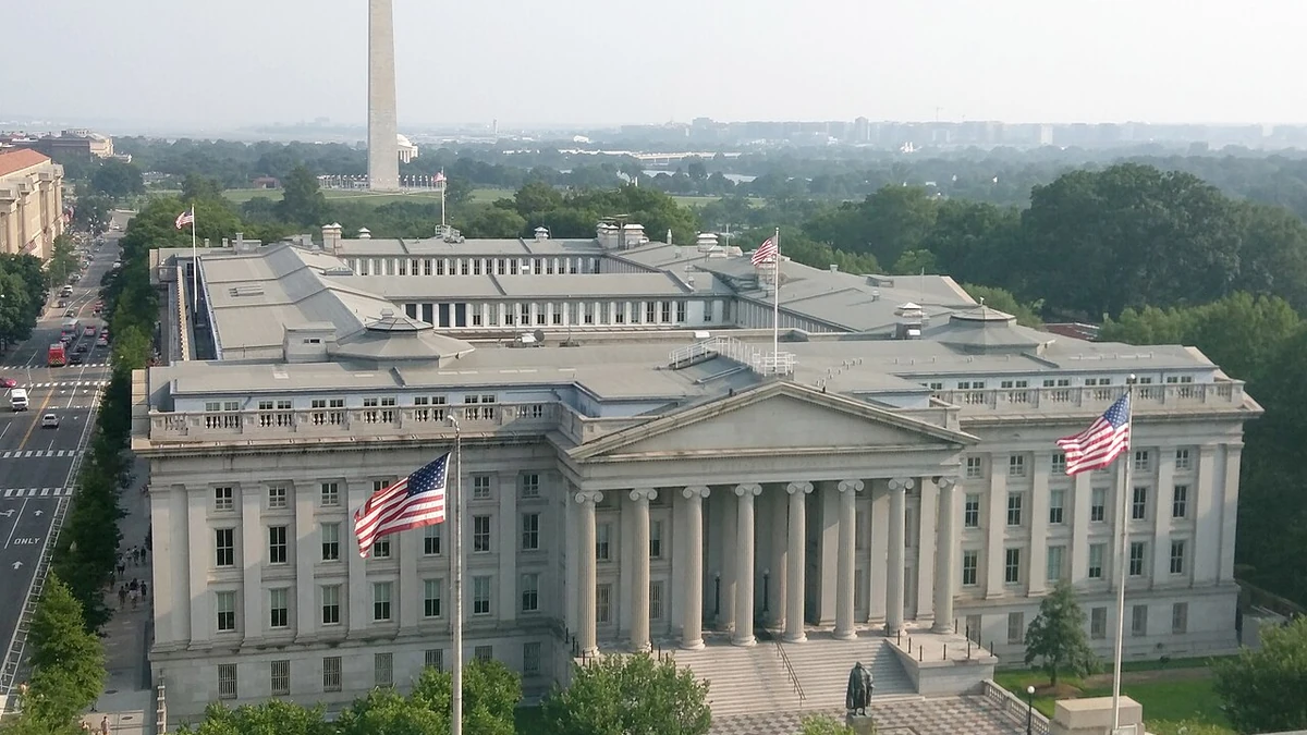 U.S. Treasury Building in Washington, D.C., with the Washington Monument in the background.