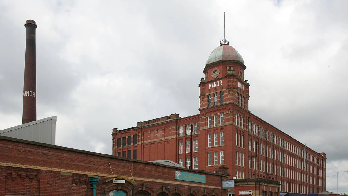 Red-brick Manor Mill in Chadderton, Greater Manchester, with its tower and chimney.