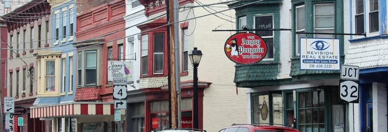 Storefronts and parked vehicles along Broad Street in Waterford, New York.