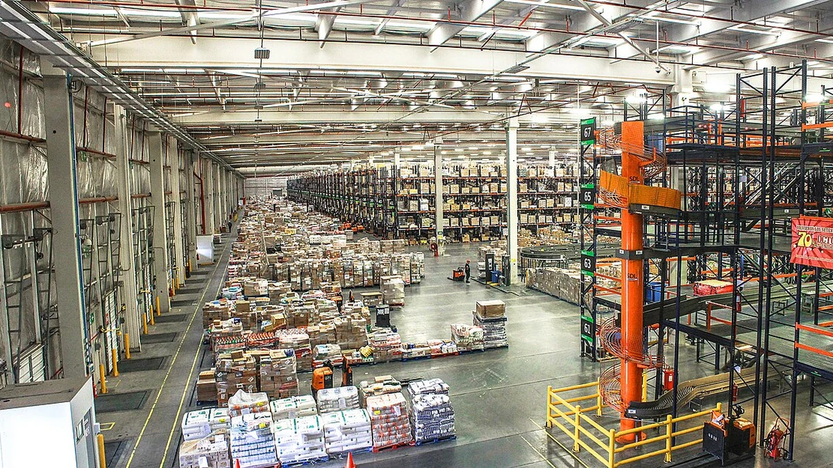 Goods stored on racks and pallets inside a large warehouse distribution center.