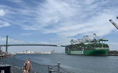 Ever Mach container ship at the Port of Los Angeles with the Vincent Thomas Bridge in the background.