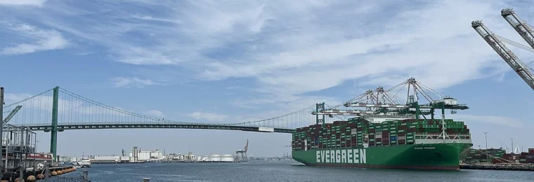 Ever Mach container ship at the Port of Los Angeles with the Vincent Thomas Bridge in the background.