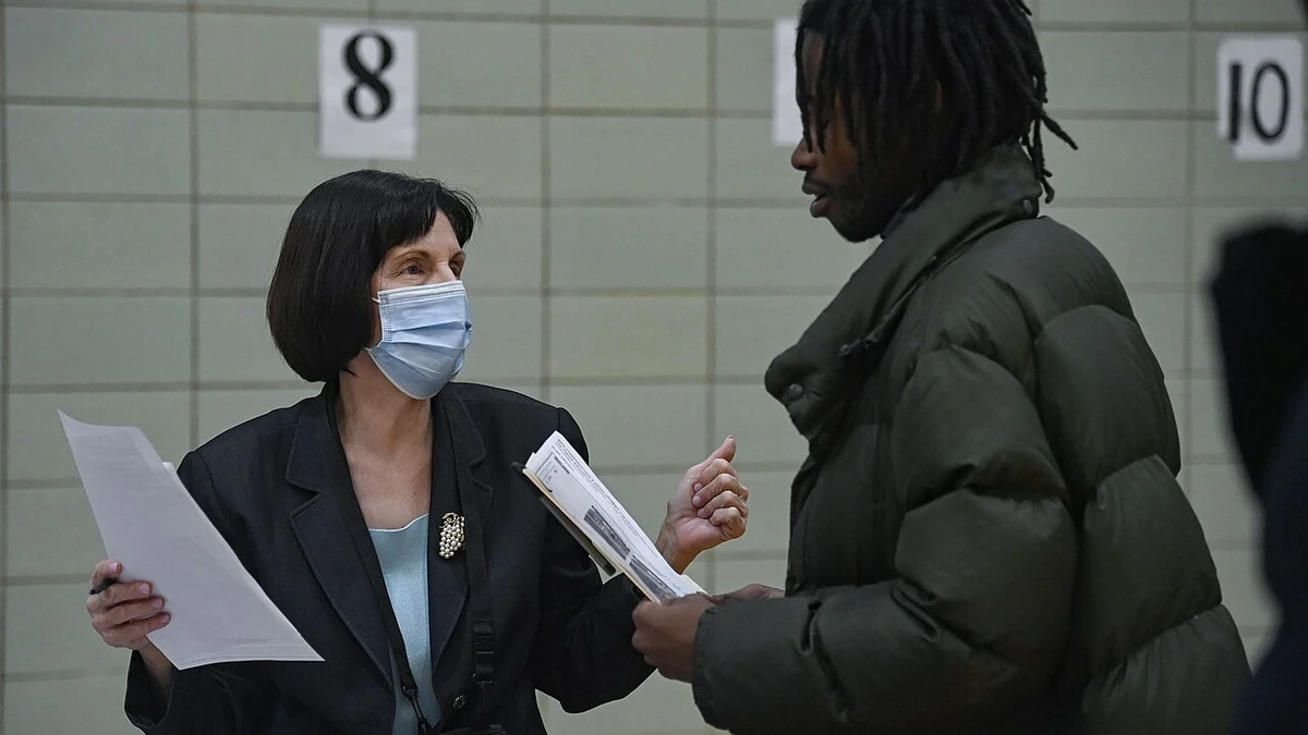 A staff member speaks with a job seeker at a job fair in East Harlem, New York.