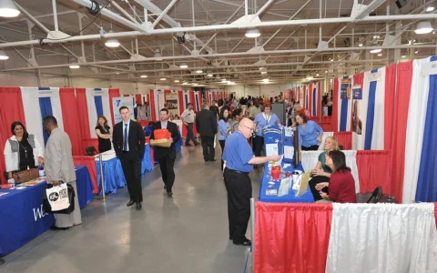 Job seekers and employer booths at a veterans job fair in Indianapolis, Indiana.