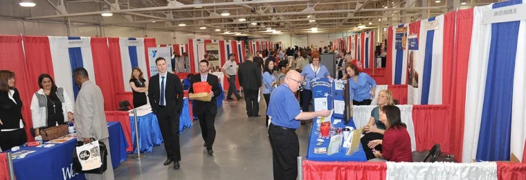 Job seekers and employer booths at a veterans job fair in Indianapolis, Indiana.