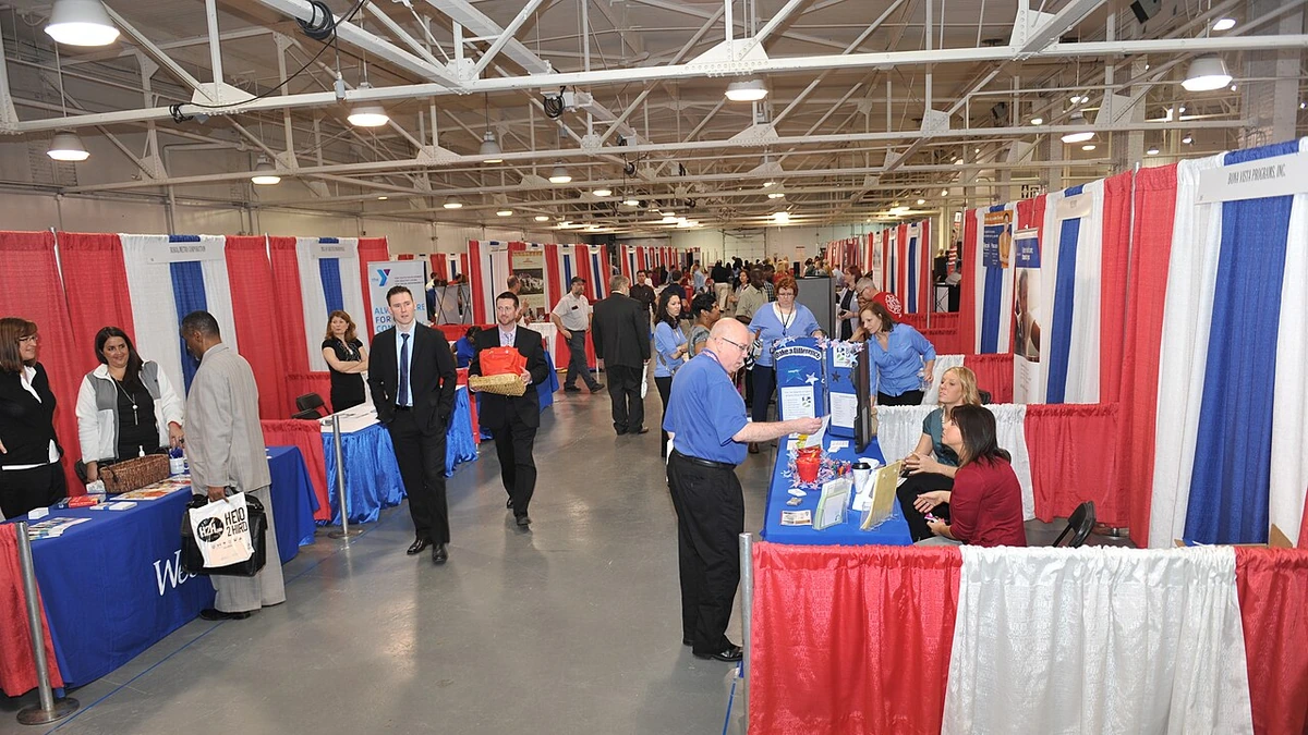 Job seekers and employer booths at a veterans job fair in Indianapolis, Indiana.