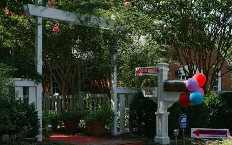 Open house and for sale by owner signs outside a home in Durham, North Carolina.