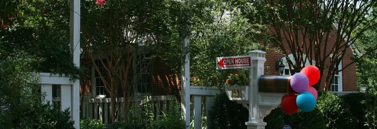 Open house and for sale by owner signs outside a home in Durham, North Carolina.