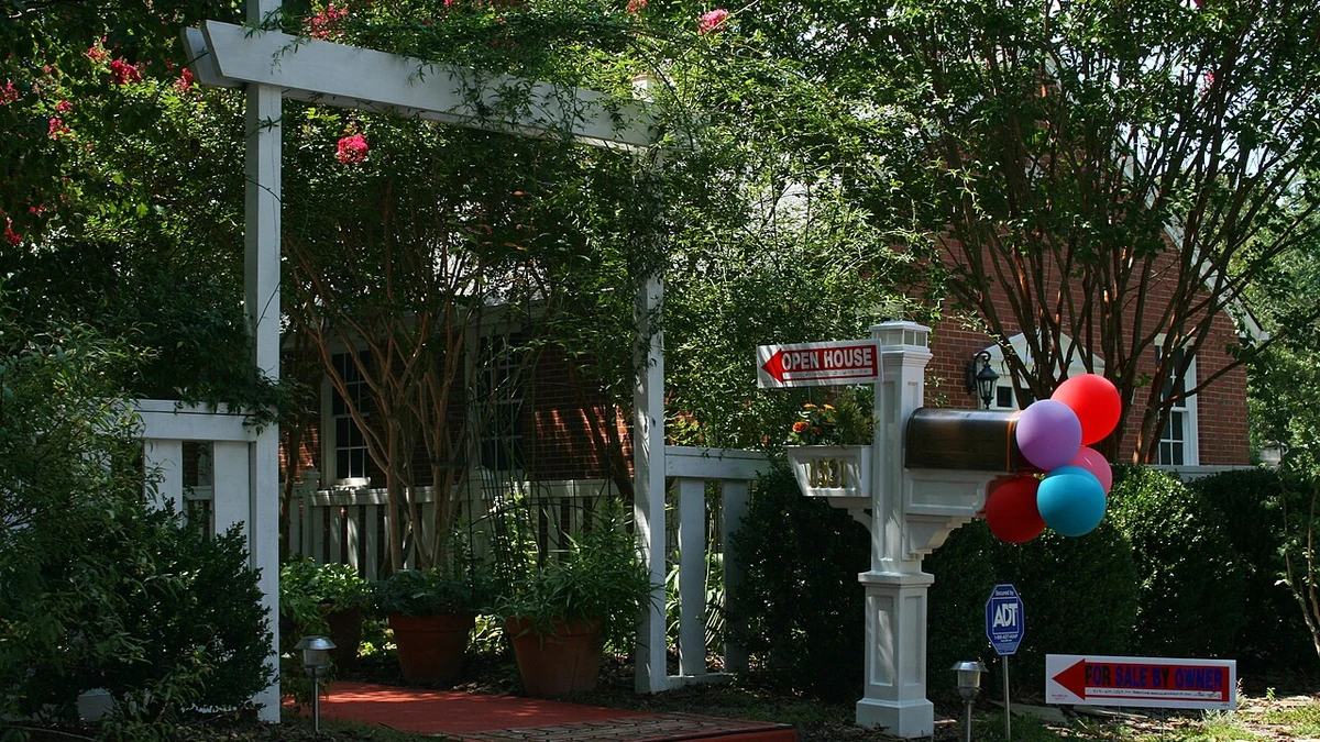 Open house and for sale by owner signs outside a home in Durham, North Carolina.