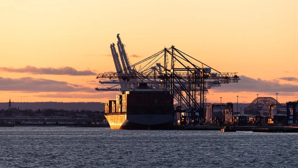 Container ship and cargo cranes at Port Jersey in Upper New York Bay at sunset.