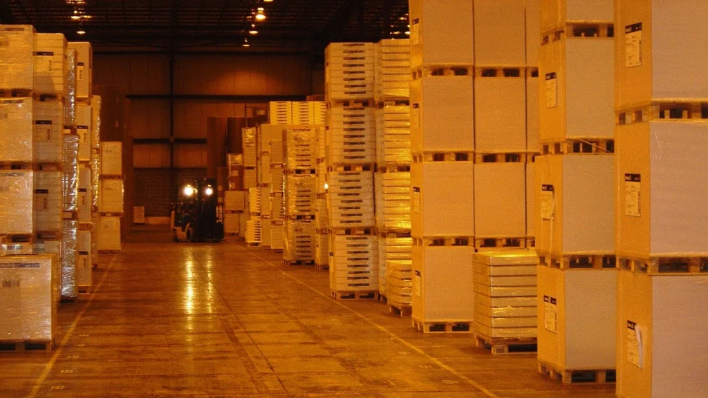 Boxes and palletized goods stacked along aisles inside a warehouse in Allentown, Pennsylvania.