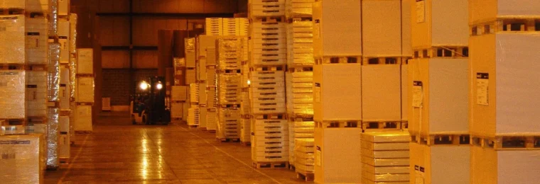 Boxes and palletized goods stacked along aisles inside a warehouse in Allentown, Pennsylvania.