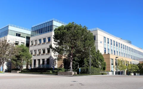 Modern office buildings and trees at Amgen headquarters in Thousand Oaks, California.