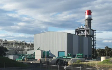 Gas-fired Tallawarra Power Station at Yallah in New South Wales, with its red-topped exhaust stack and generating building.