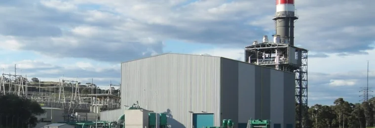 Gas-fired Tallawarra Power Station at Yallah in New South Wales, with its red-topped exhaust stack and generating building.