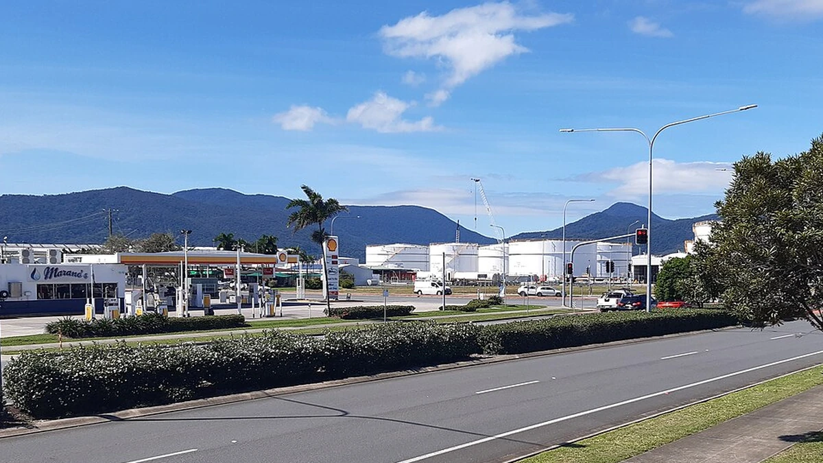Fuel and gas storage tanks near Cairns Seaport, Queensland, with a roadside petrol station in the foreground.