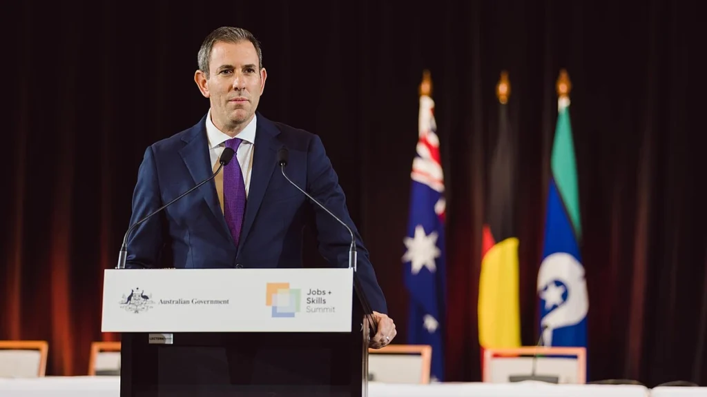 Australian Treasurer Jim Chalmers speaking at a lectern at Parliament House in Canberra.