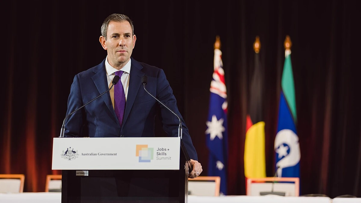 Australian Treasurer Jim Chalmers speaking at a lectern at Parliament House in Canberra.