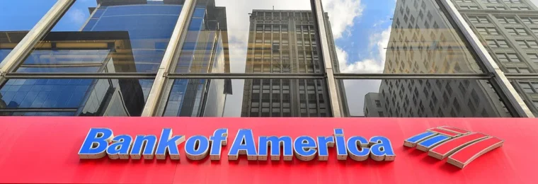 Bank of America signage at a Chicago branch beneath reflective glass windows.