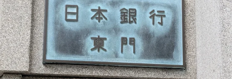 Japanese-language Bank of Japan East Gate sign mounted on the stone wall of its Tokyo headquarters.