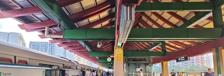 Lakeside MRT station platform in Singapore with an East-West Line train and passengers.