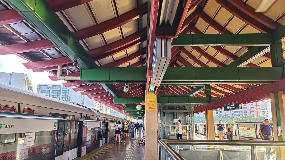 Lakeside MRT station platform in Singapore with an East-West Line train and passengers.