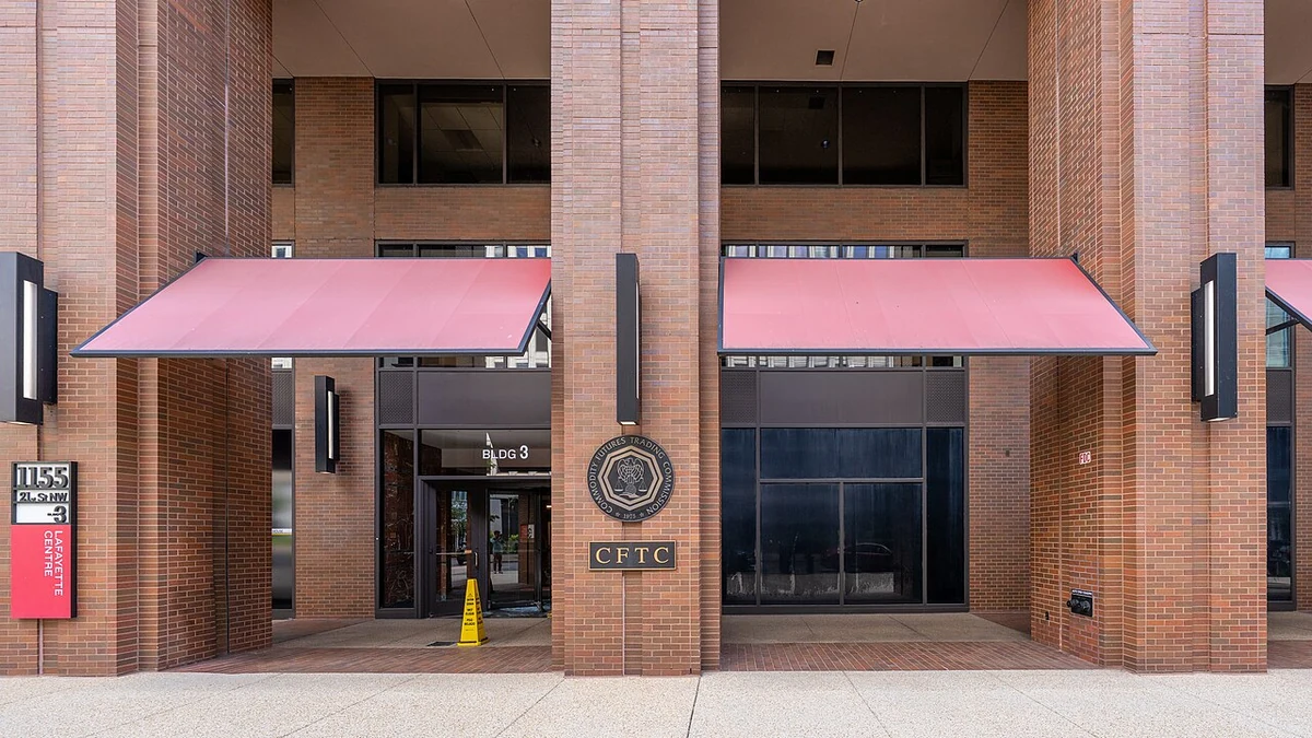 Entrance to the Commodity Futures Trading Commission offices in Washington, D.C., with the CFTC seal on a brick column.