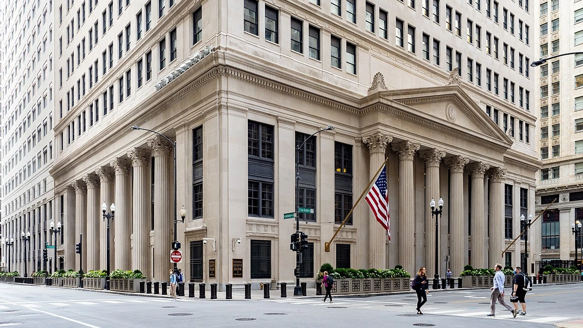 Exterior of the Federal Reserve Bank of Chicago building, with columns and an American flag.
