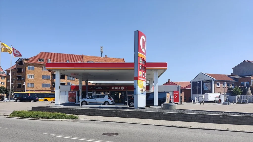 Circle K petrol station in Denmark with forecourt, pumps and price sign visible.