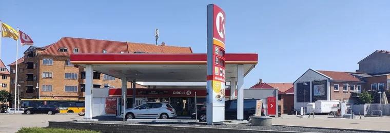 Circle K petrol station in Denmark with forecourt, pumps and price sign visible.