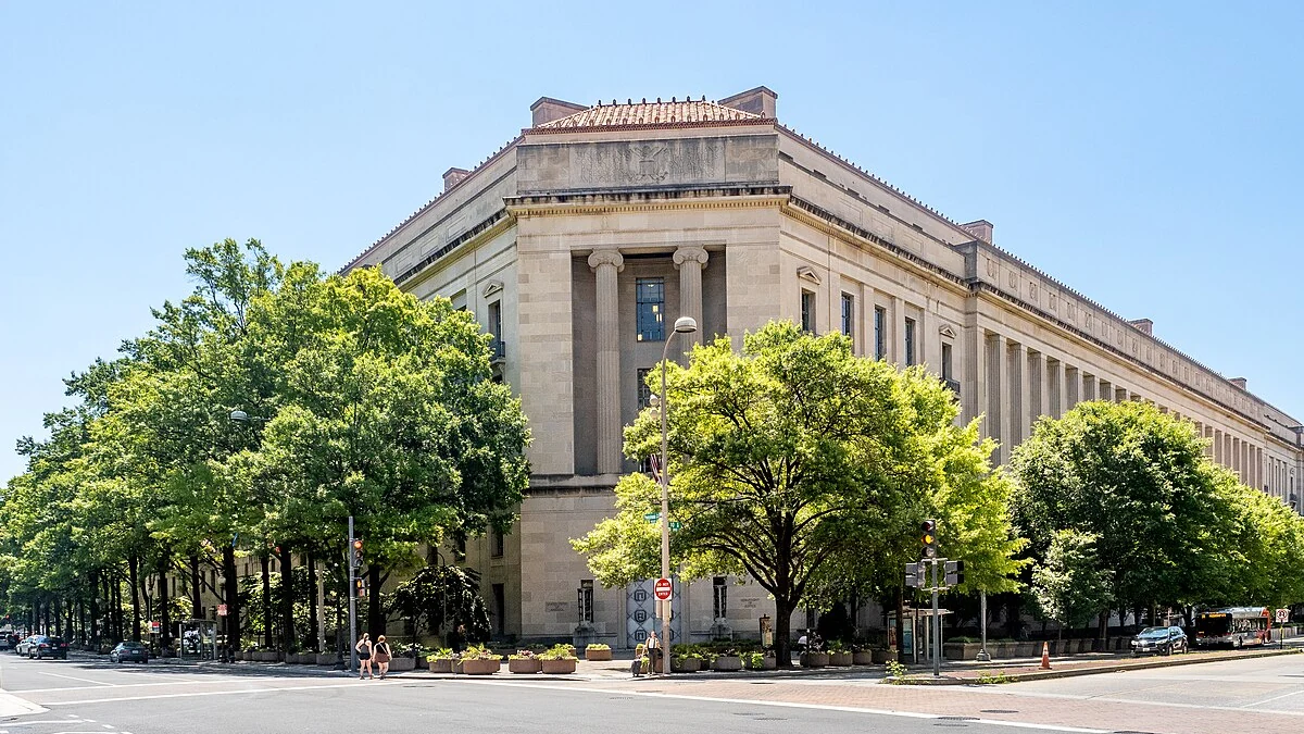 Robert F. Kennedy Department of Justice Building in Washington, D.C., with trees along the street.