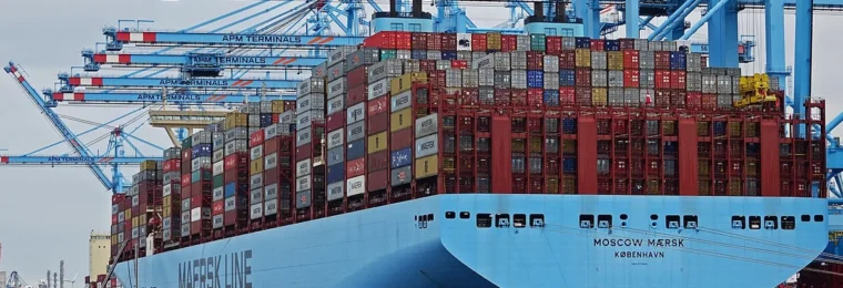 The Moscow Maersk container ship alongside blue container cranes at APM Terminals Maasvlakte 2 in Rotterdam, Netherlands.