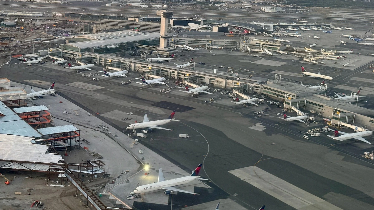 Aerial view of John F. Kennedy International Airport Terminal 4, the control tower and aircraft on the apron.